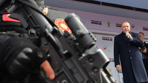 Turkish President Recep Tayyip Erdogan speaks as a security staff member stands guard in foreground during a rally of Justice and Development Party (AK Party) in Ankara, Turkey, on March 28, 2019. (Anadolu Agency/Getty Images)