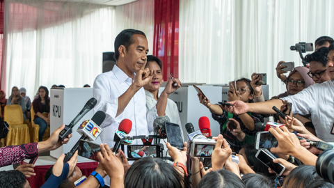 Indonesian President Joko Widodo and his wife Iriana speak to journalist after the election at a polling station in Jakarta, Indonesia, on April 17, 2019. (Barcroft Media/Getty Images)