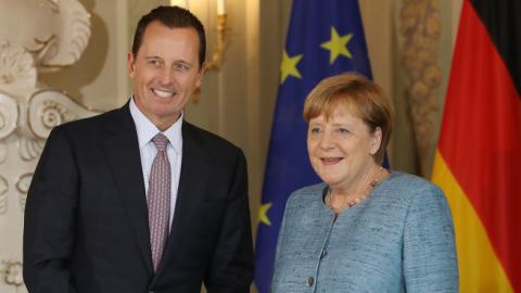 U.S. Ambassador Richard Grenell poses for a photo with German Chancellor Angela Merkel at Schloss Meseberg palace on July 6, 2018 near Gransee, Germany. (Sean Gallup/Getty Images)
