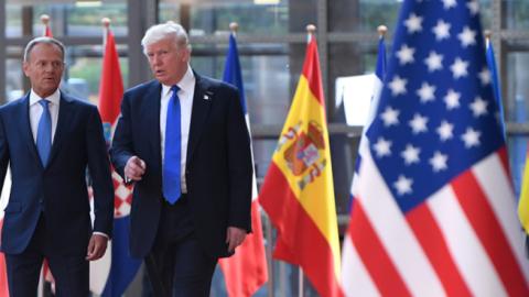 US President Donald Trump gestures as he speaks to European Council President Donald Tusk upon his arrival at EU headquarters in Brussels, on May 25, 2017. (EMMANUEL DUNAND/Getty Images) 