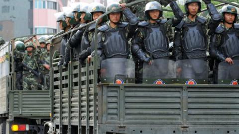 Trucks carrying armed police officers run towards the residential area of Uighur people on July 8, 2009 in Urumqi, the capital of Xinjiang Uighur autonomous region, China. (The Asahi Shimbun/Getty Images)