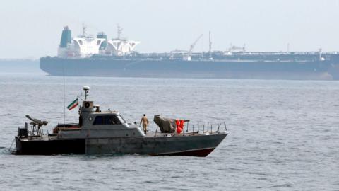 A picture taken on March 12, 2017, shows an Iranian military speedboat patrols the waters as a tanker perpares to dock at the oil facility in the Khark Island, on the shore of the Gulf. (AFP/Getty Images)