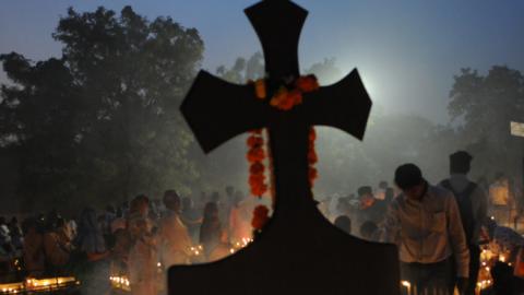 Christians offering prayers for the departed souls of their loved ones on the occasion of All Souls Day, at a cemetery on November 2, 2016 in Bhopal, India. (Hindustan Times/Getty Images)