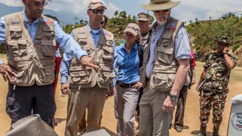 USAID staff are briefed during a visit to Nepal in the wake of a devastating 2015 earthquake. (USAID/Flickr)