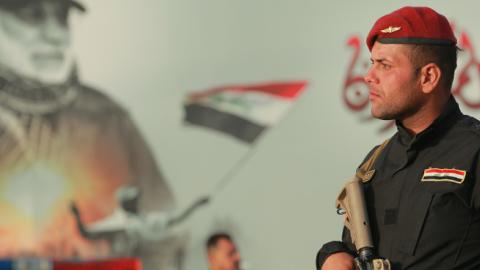 An armed member of the Iraqi Special Operations Forces secures a conference being held by the predominantly Shia Muslim Popular Mobilization Forces to honour Iranian fighters who died fighting the Islamic State. (Ameer Al Mohammedaw/Getty Images)