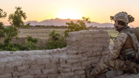An Afghan Commando keeps an eye on the horizon at the end of the day in Pesaw village, Bala Balouk district, Farah province, Afghanistan, May 21, 2018. (NATO photo by Lt. Amy Forsythe)