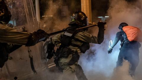 Riot police charge toward protesters in a fume of tear gas on an express way at Causeway Bay district on August 4, 2019 in Hong Kong, China. (Anthony Kwan/Getty Images)