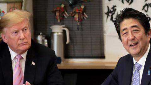 Shinzo Abe, Japan's Prime Minister, right, speaks as U.S. President Donald Trump looks on while sitting at a counter during a dinner at the Inakaya restaurant in the Roppongi district on May 26, 2019 in Tokyo, Japan. (Pool/Getty Images)