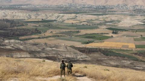 Israeli soldiers overlooking the Jordan Valley in June 2019. (Abir Sultan/Agence France-Presse/Getty Images)