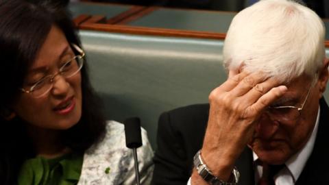 Independent MP Bob Katter hides his face as he sits next to Liberal backbencer Gladys Liu during a division in Question Time in the House of Representatives on September 16, 2019 in Canberra, Australia. (Getty Images)