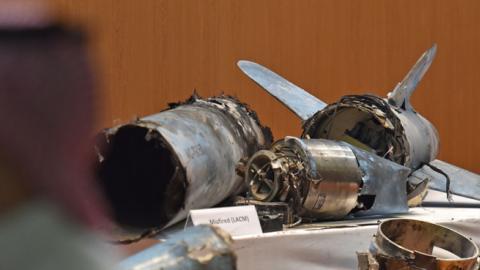 Displayed fragments of what the Saudi defence ministry spokesman said were Iranian cruise missiles and drones recovered from the attack site that targeted Saudi Aramco's facilities. (FAYEZ NURELDINE/Getty Images) 
