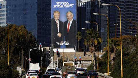 A picture taken on February 3, 2019 in the Israeli coastal city of Tel Aviv shows a giant election billboard of Israeli Prime Minister Benjamin Netanyahu and US President Donald Trump shaking hands. (JACK GUEZ/Getty Images)