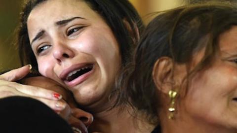 Women mourn for the victims of the blast at the Coptic Christian Saint Mark’s church east of Alexandria