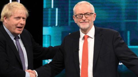 Prime Minister Boris Johnson and Leader of the Labour Party Jeremy Corbyn shake hands during the ITV Leaders Debate at Media Centre on November 19, 2019 in Salford, England. (ITV via Getty Images)