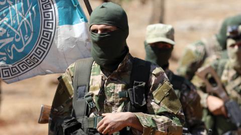 Syrian fighters attend a mock battle in anticipation of an attack by the regime on Idlib province during a graduation of new HTS members at a camp in the countryside of the northern Idlib province August 14, 2018. (Getty Images)