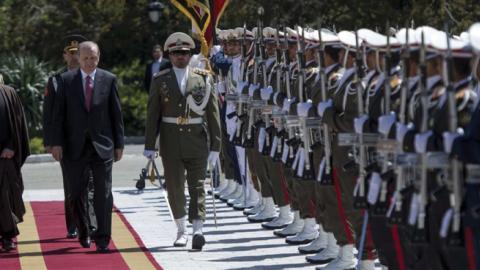 Turkish President Recep Tayyip Erdogan and Iran's President Hassan Rouhani review the honor guard during official welcoming ceremony at Saadabad Palace in Tehran, Iran on April 7, 2015. (Anadolu Agency/Getty Images)