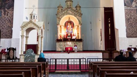 Iranian Armenian Christians pray in front of an altar in Saint Sarkis Cathedral in Tehran, Iran on September 27, 2018