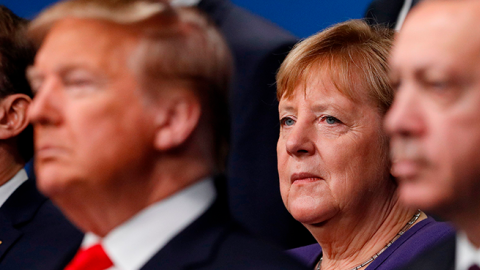 France's President Emmanuel Macron and German Chancellor Angela Merkel pose with NATO leaders including U.S. President Donald Trump for the family photo at the NATO summit in London on December 4, 2019. (PETER NICHOLLS/AFP via Getty Images)