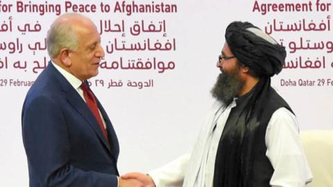 Taliban co-founder Mullah Abdul Ghani Baradar (R) and U.S. Special Representative for Afghanistan Reconciliation Zalmay Khalilzad (L) shake hands as they exchange peace agreement documents during the signing ceremony on February 29, 2020 in Doha, Qatar