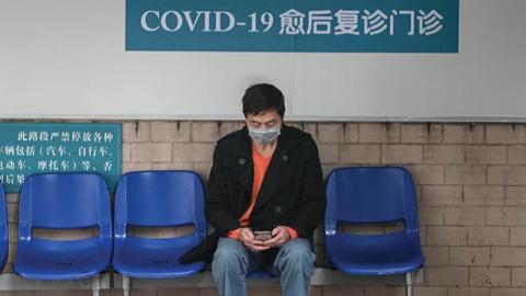 A cured coronavirus patient waits outside an outpatient department of Guangdong Second Provincial General Hospital on March 4, 2020 in Guangzhou, Guangdong Province of China. The hospital sets up the department especially for cured patients to better moni