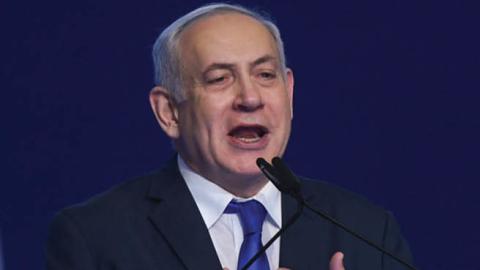 Israeli Prime Minister Benjamin Netanyahu gestures as he speaks to supporters following the announcement of exit polls in Israel's election at his Likud party headquarters in Tel Aviv.
