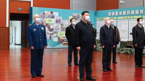 Chinese President Xi Jinping, also general secretary of the Communist Party of China Central Committee and chairman of the Central Military Commission, hears a report on the scientific research on COVID-19, March 2, 2020. (Getty Images)