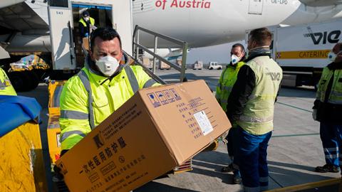 Some 130 tons of protective gear is unloaded an Austrian Airline airplane arrived from China and bound for Italy at Vienna Airport in Schwechat, Lower Austria on March 23, 2020. (GEORG HOCHMUTH/APA/AFP via Getty Images)