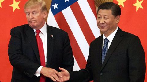 President Donald Trump and China's President Xi Jinping shake hands at a press conference following their meeting outside the Great Hall of the People in Beijing on November 9, 2017. (Artyom Ivanov\TASS via Getty Images)