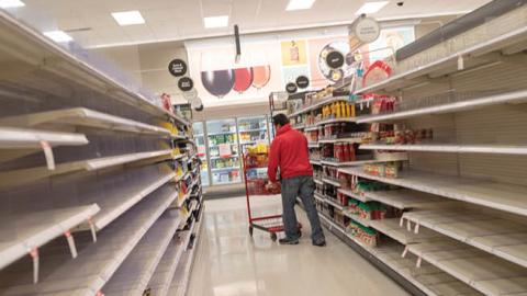 Empty shelves and shoppers are visible at a Target retail store during an outbreak of the COVID-19 coronavirus in Contra Costa County, Dublin, California, March 15, 2020. 