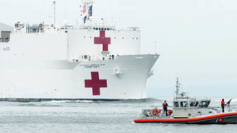The Military Sealift Command hospital ship USNS Comfort (T-AH 20) is escorted by U.S. Coast Guard, New York Police Department and New York Fire Department assets as the ship arrives in in New York City, March 30, 2020