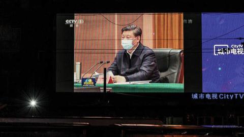 A large screen in the street shows Chinese president Xi Jinping wearing a protective mask during his visit to Wuhan earlier in the day, the epicentre of the coronavirus, on CCTV's evening newscast on March 10, 2020 in Beijing, China.