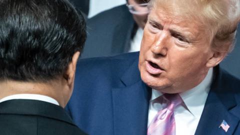 Xi Jinping, President of China, and Donald Trump, President of the United States of America (USA), chat as they pose for the group photo at the beginning of the G20 summit. 