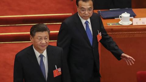 Chinese President Xi Jinping and Chinese Premier Li Keqiang walk into the Great Hall of the People at the beginning of the Second Plenary Session of the National People's Congress on May 25, 2020 in Beijing, China