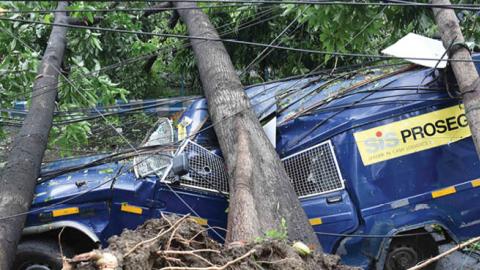 A security van is crushed by an uprooted tree in the aftermath of Cyclone Amphan at Beliaghata on May 21, 2020 in Kolkata, India.