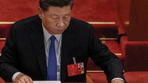 Chinese president Xi Jinping arranges his papers at the closing session of the National People's Congress, which included a vote on a new draft security bill for Hong Kong, at the Great Hall of the People on May 28, 2020 in Beijing, China. 