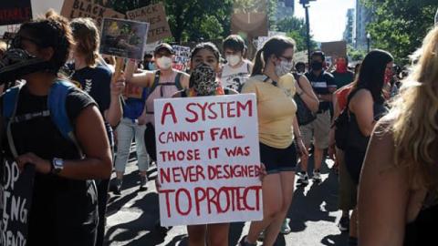 Demonstrators march at a peaceful protest against police brutality on Sunday in Washington, D.C.