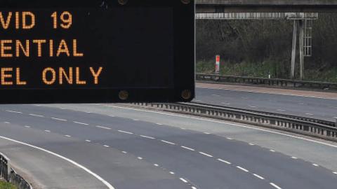 A motorway sign on the M8 motorway advising on essential travel only on March 24 in Glasgow, Scotland.