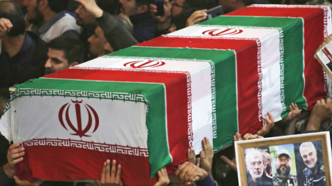 Mourners carry the coffins of slain Iraqi paramilitary chief Abu Mahdi al-Muhandis, Iranian military commander Qasem Soleimani and eight others during a funeral procession in Iraq on January 4, 2020. (Photo by MOHAMMED SAWAF/AFP via Getty Images)