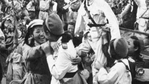 North Korean and Chinese troops celebrate a victory against U.S. forces in South Korea, c. June 25, 1950.