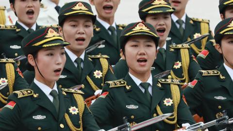 Female soldiers of the Guard of Honour of the People's Liberation Army shout as they walk in front of Chinese President Xi Jinping and Kazakh President Kassym Jomart Tokayev (not pictured) during the welcoming ceremony at the beginning of the meeting on 