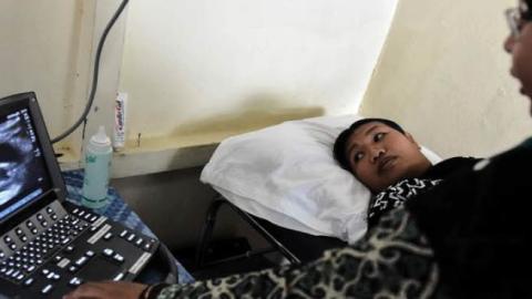 A doctor performs an ultrasound on a pregnant woman in Sukadana, Indonesia, Aug. 3, 2016.