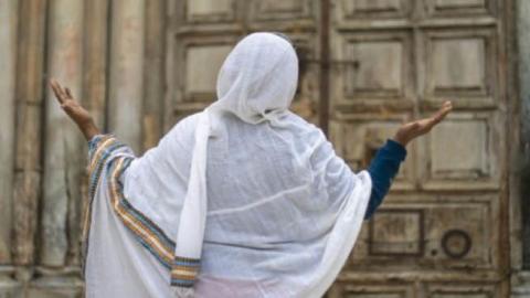 An Ethiopian Christian prays outside the Church of the Holy Sepulchre in Jerusalem, April 19, 2020. 