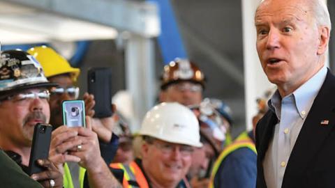Democratic presidential candidate Joe Biden meets workers as he tours the Fiat Chrysler plant in Detroit, Michigan on March 10, 2020.