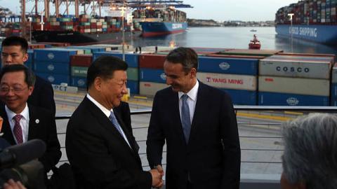 President of the Republic of China Xi Jinping (L) and Greek Prime Minister Kyriakos Mitsotakis (R) shake hands as they visit the cargo terminal of Chinese company Cosco in the port of Piraeus, Greece, on November 11, 2019, as part of his two-day official 
