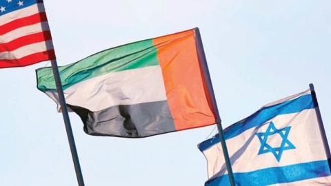 A U.S., Emirati, Israeli and Bahraini flag fly over a road in Netanya, Israel, Sept. 13.