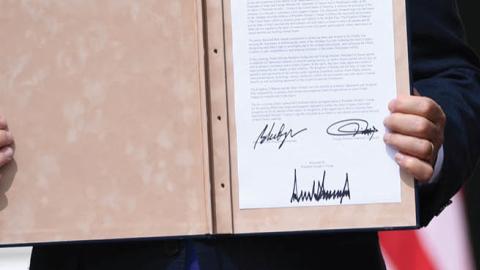 Israeli Prime Minister Benjamin Netanyahu holds up the document after participating in the signing of the Abraham Accords where the countries of Bahrain and the United Arab Emirates recognize Israel, at the White House on Sept. 15, 2020