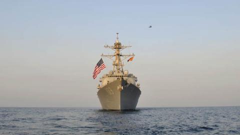 SH-60B Sea Hawk helicopter and helicopters from US Army 35th Combat Aviation Brigade fly in formation over guided-missile destroyer USS Jason Dunham (DDG 109) after US Army-Navy interoperability training.