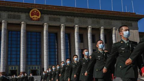 Chinese soldiers from the People's Liberation Army wear protective masks as they march after a ceremony marking the 70th anniversary of China's entry into the Korean War, on October 23, 2020 at the Great Hall of the People in Beijing, China.