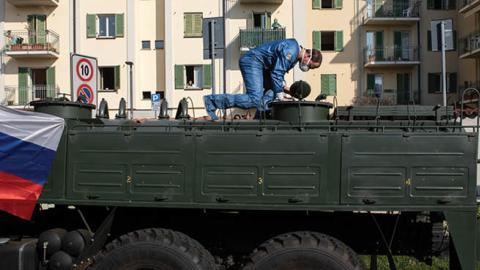 A Russian Army officer controls a manhole over a truck at Istituto Palazzolo nursing home on April 09, 2020 in Torre Boldone, Italy