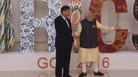 Indian Prime Minister Narendra Modi (R) shakes hands with China's President Xi Jinping prior to the BRICS Summit welcoming ceremony at the Taj Exotica hotel in Goa on October 16, 2016.
